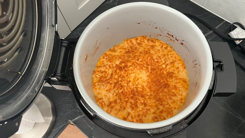 Buffalo chicken dip with browned cheese topping finished in the Ninja Foodi.