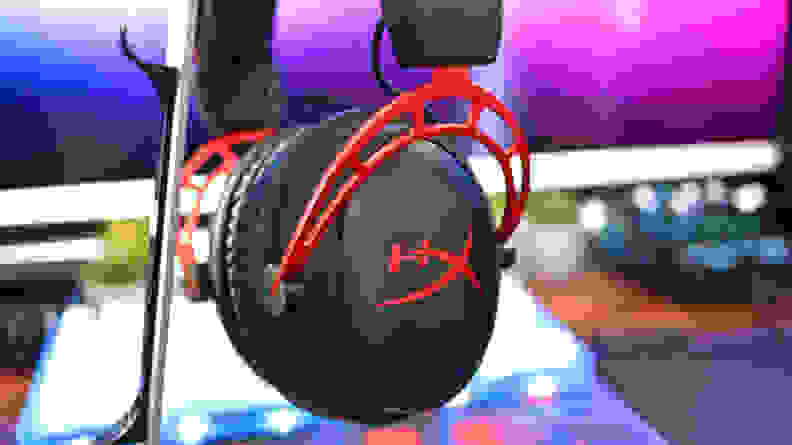 A close up of a black and red gaming headset without an attached mic