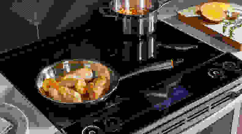 Chicken and soup cooking on an induction cooktop
