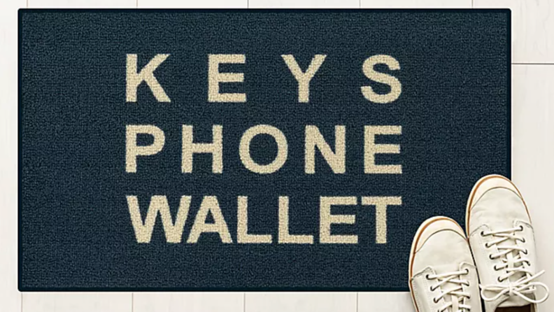 Door mat that says "Keys Phone Wallet"