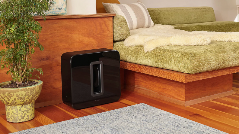 A Sonos Sub sits in a living room.