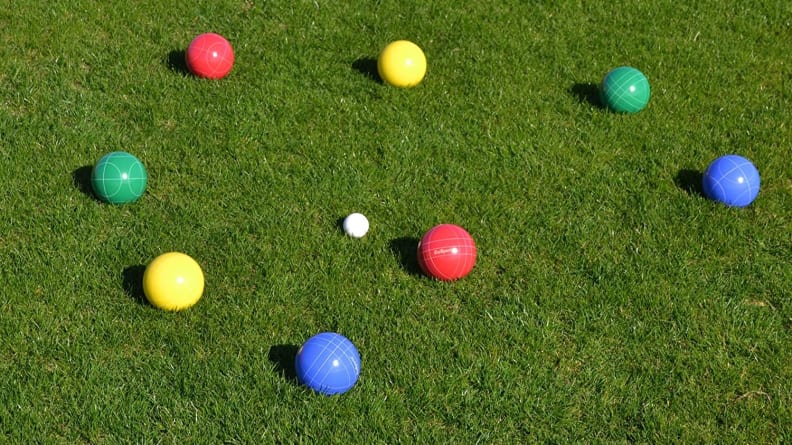 Close up of colorful boccee balls on a lawn.