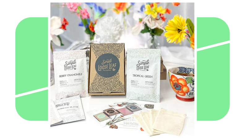 A subscription box of Simple Loose Leaf Tea Company products laid out next to flowers.