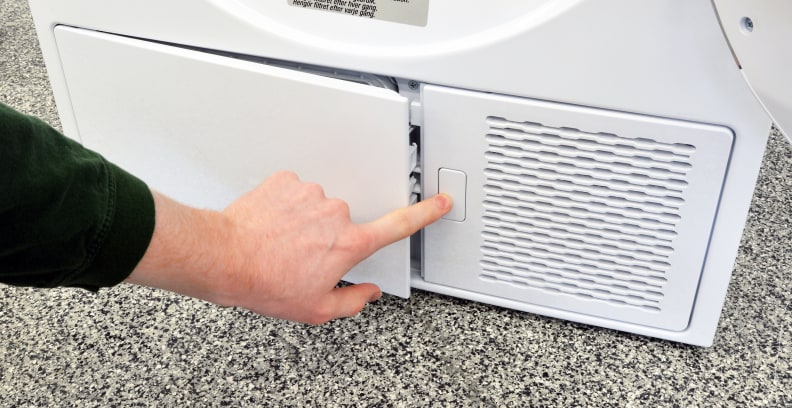 The small white button under the Blomberg DHP24412W's door pops open a "hidden" compartment that houses the secondary lint trap.