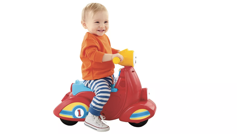 A baby on a toddler scooter