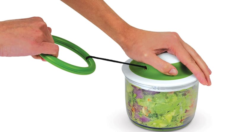 Person pulling VeggiChop to make guacamole.