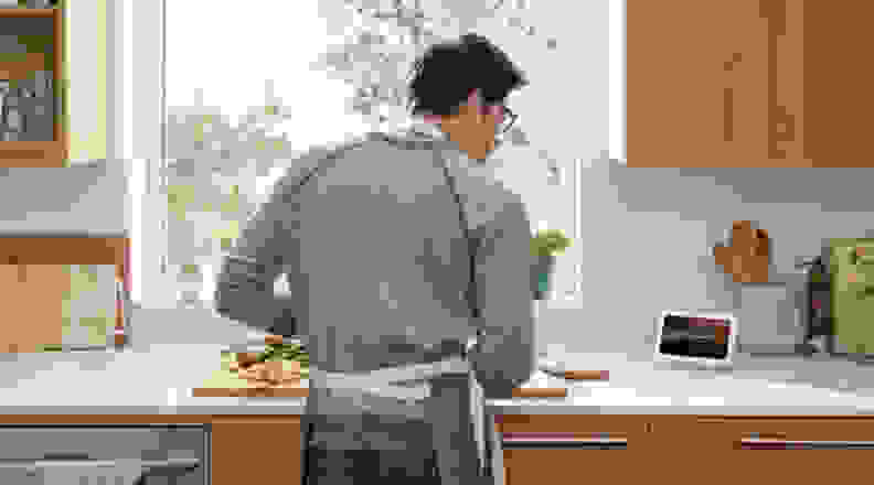 Man in kitchen with Google Nest Hub