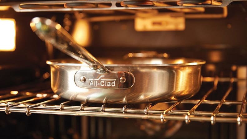 An All-Clad skillet inside an oven.