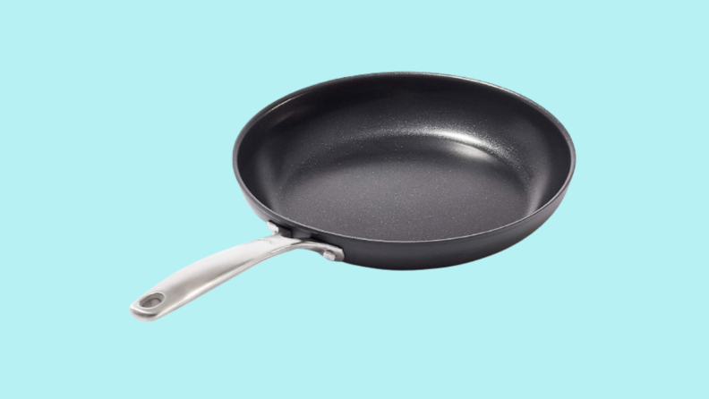 Nonstick frying pan against cyan background