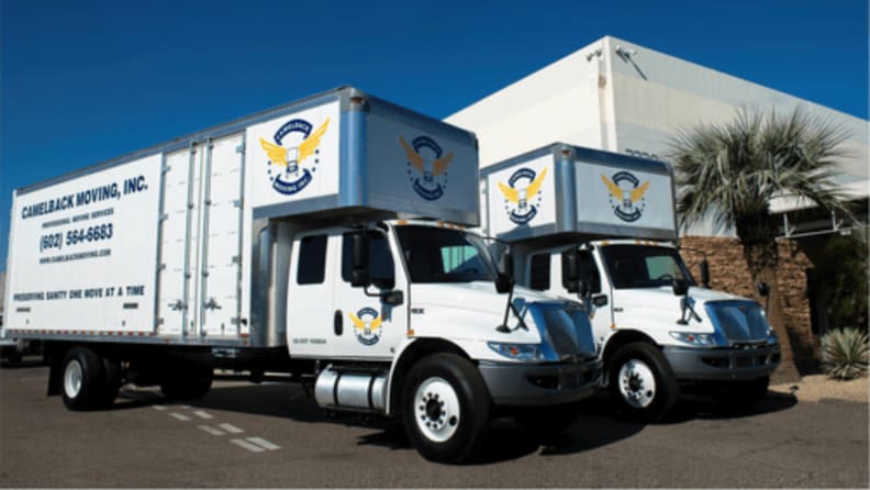 Two large white moving trucks