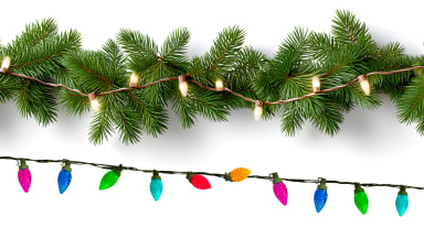White string lights on evergreen garland above a string of colored lights