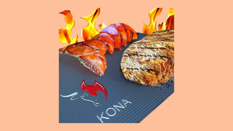 Meat with grill marks and a lobster tail on a Kona Non-Stick BBQ Grill Mat.