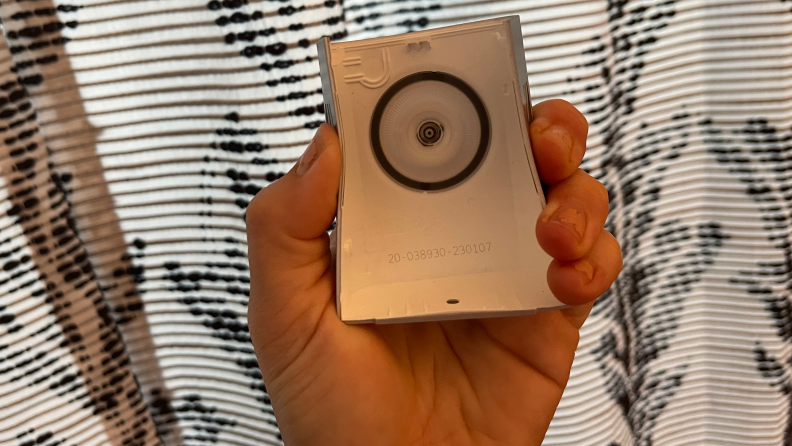 A hand squeezing the Ring Battery Doorbell Plus  faceplate