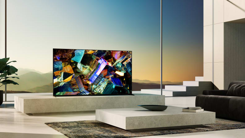 The Sony Z9K television on a marble entertainment center. In the background, windows overlooking mountains.