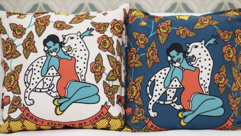 Two colorful pillows with woman and leopard design