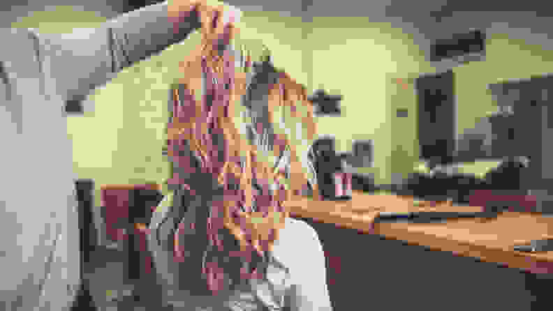Wavy hairstyle of young woman sitting in a hair salon