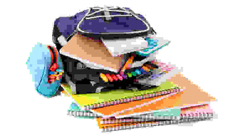 Backpack overfilled with school supplies