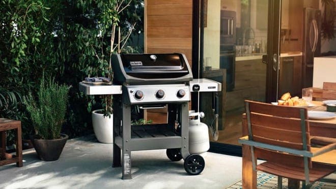 Silver and black grill on patio