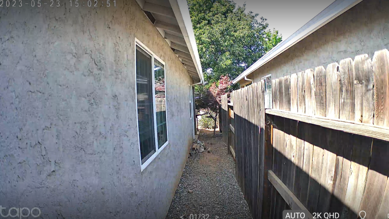 A clear video feed of the side of a house.