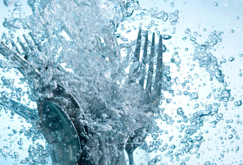 Cutlery in water surrounded by bubbles