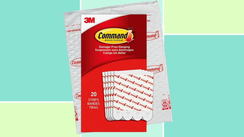 A packet of Command strips against a blue and green background.