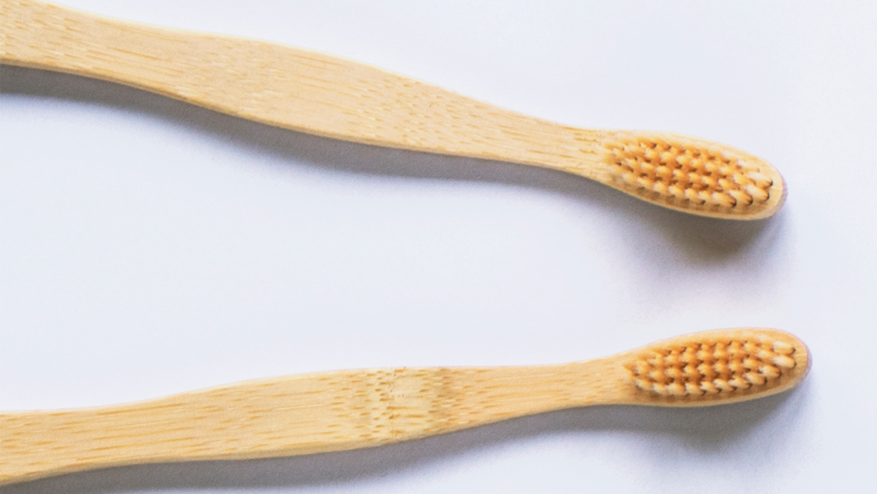 Two wooden toothbrushes.