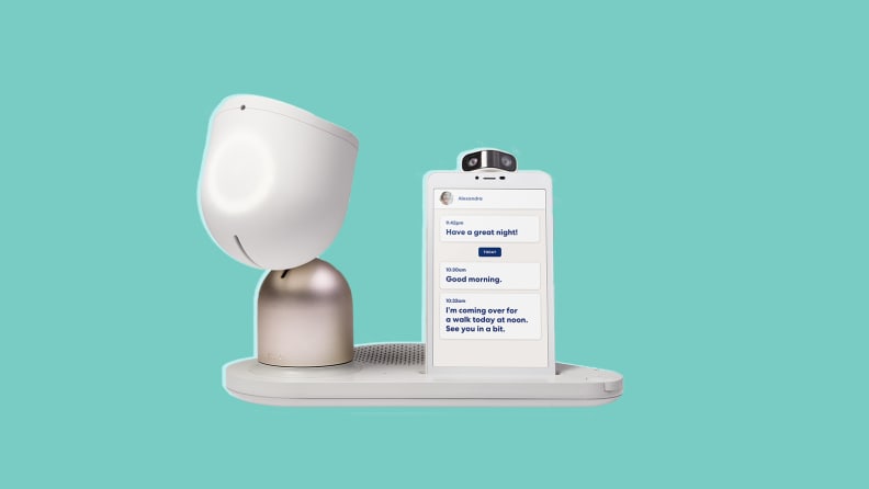 The ElliQ device with a smartphone attached in front of a background.