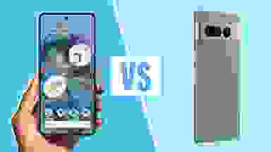 A person holding a Google Pixel 7 Pro next to a Google Pixel 8 Pro smart phone.