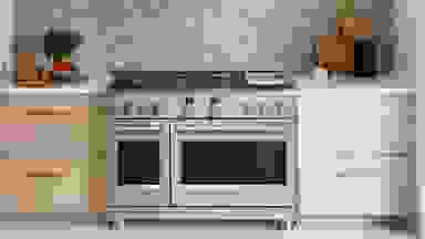 The GE Cafe C2Y486P3TD1 Gas Range hooked up in place inside a kitchen.