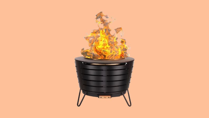 Fire pit with flames against peach background
