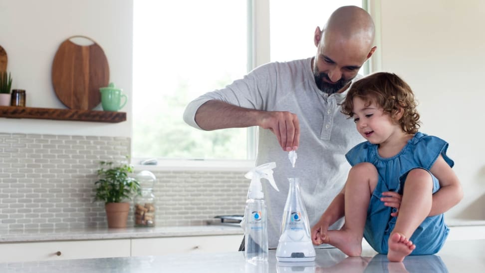 A father shows his young daughter the Force of Nature multi-surface disinfectant.