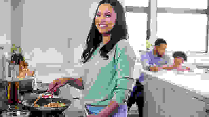 Ayesha Curry cooking by stove