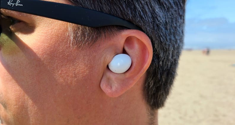 Person wearing Samsung Galaxy Buds 2 in the ear.