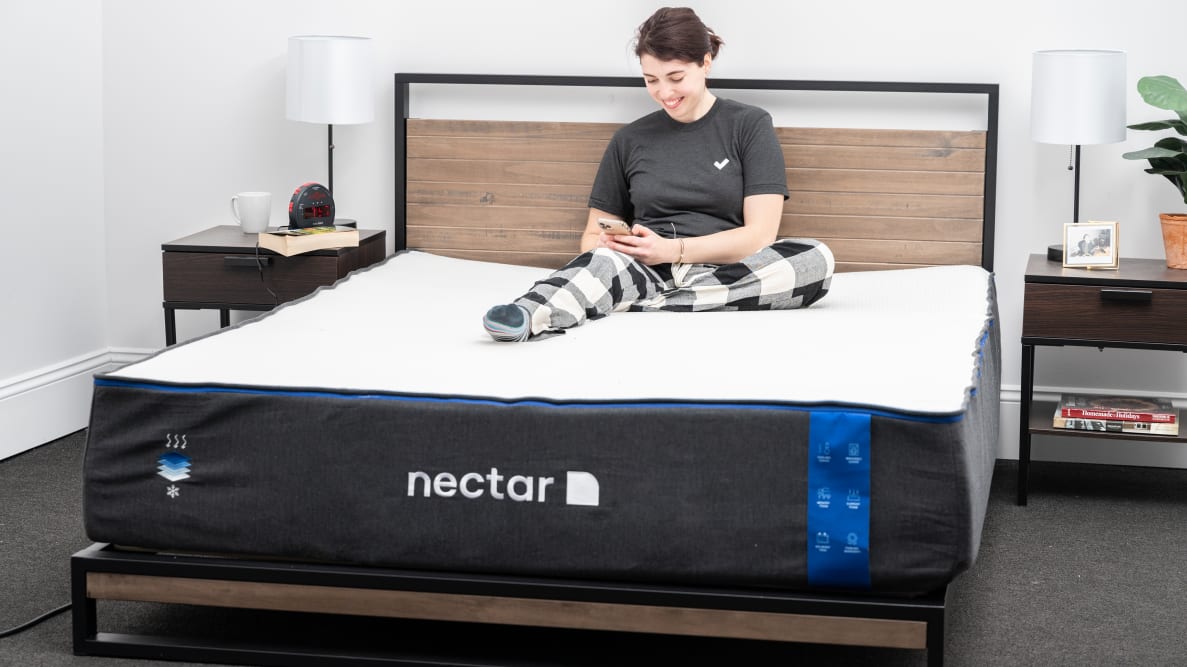 a person sits on the nectar mattress on their phone