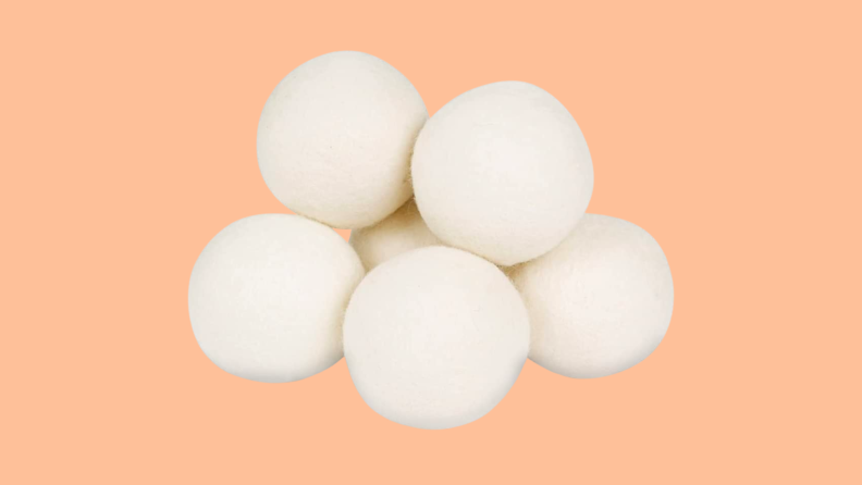 Wool dryer balls against a peach background