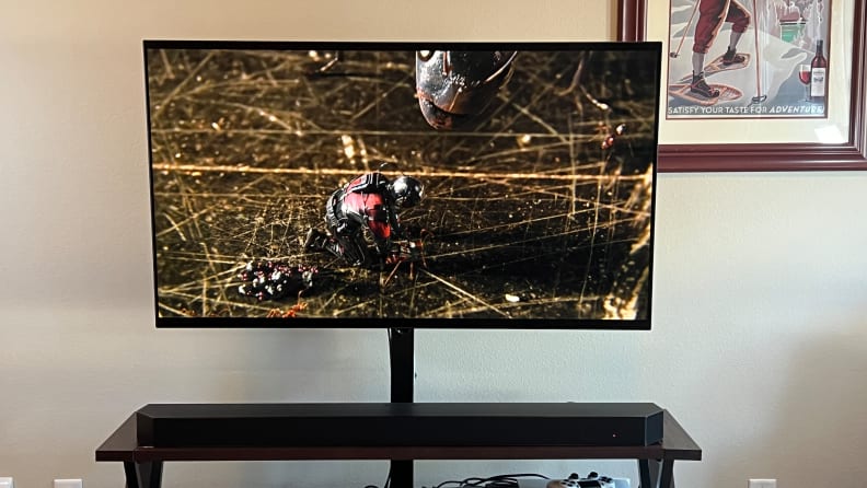 A TV with Ant-Man on the screen with sound provided by the Samsung HW-Q990B.
