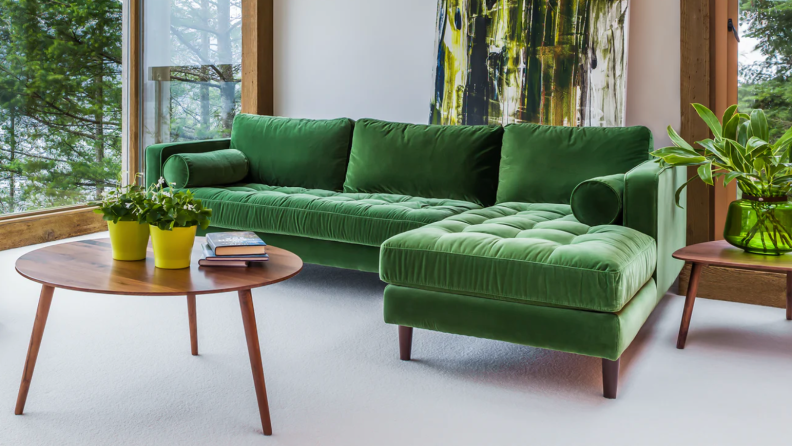 Green Article sectional sofa in a living room on a white rug.