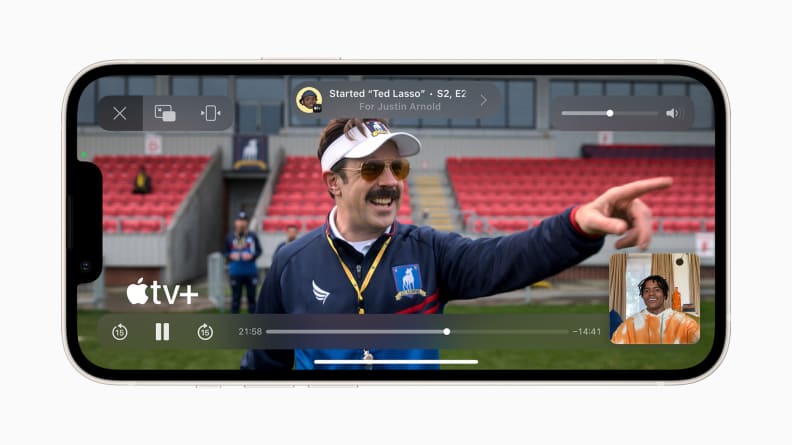An iPhone in landscape, showing a scene from the Apple TV+ show Ted Lasso.