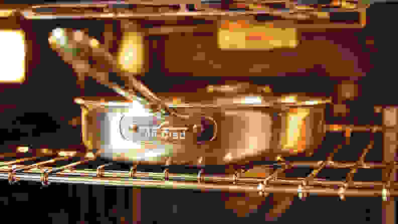An All-Clad skillet inside an oven.