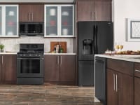 Black stainless steel appliances in a kitchen with wood cabinetry