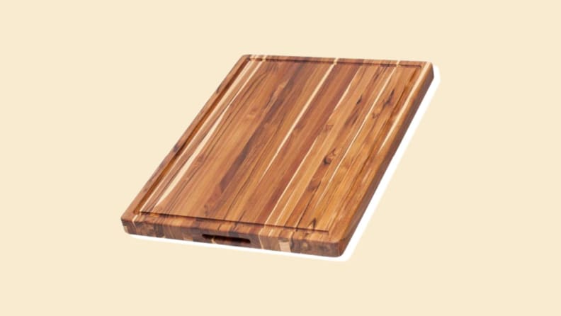 A wooden cutting board on a beige background.