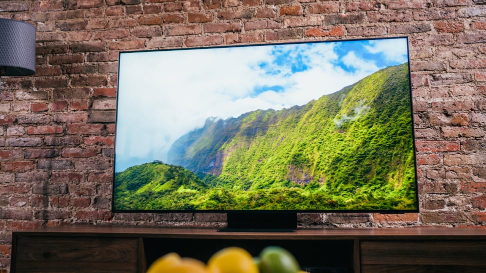 The Samsung QN90A displaying colorful 4K content in a living room setting