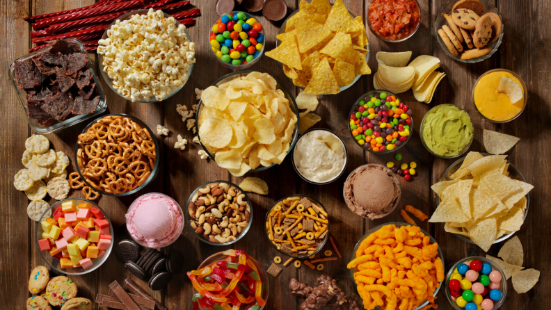 Varity of junk food and food in individual bowls.