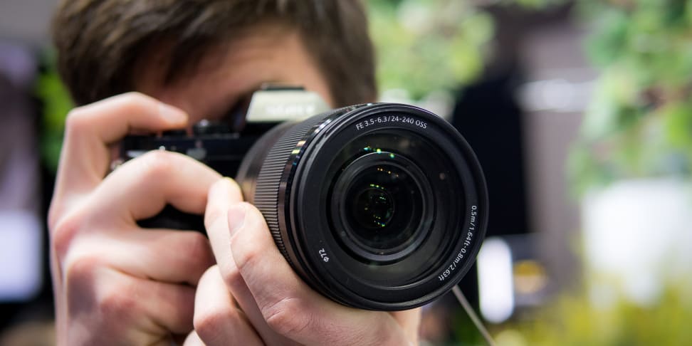 A photographer using a zoom lens