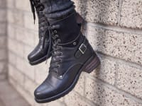 Crave boots from Taos dangling from a wall