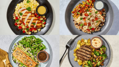 Factor is a high-protein meal delivery service that offers various spreads like paste, steak, and fish shown in the four-gridded plates.