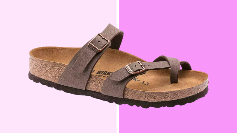 An image of a Birkenstock Mayari sandal in a warm brown color, with cork footbeds and straps that cross over the place where the foot meets the ankle and down to loop around the wearer's big toe.