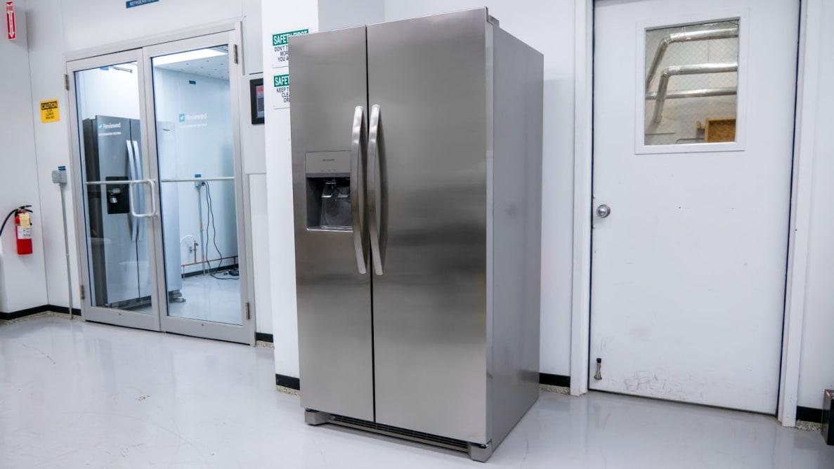 Product shot of the stainless steel Frigidaire FRSS2623AS side-by-side refrigerator inside of testing laboratory.