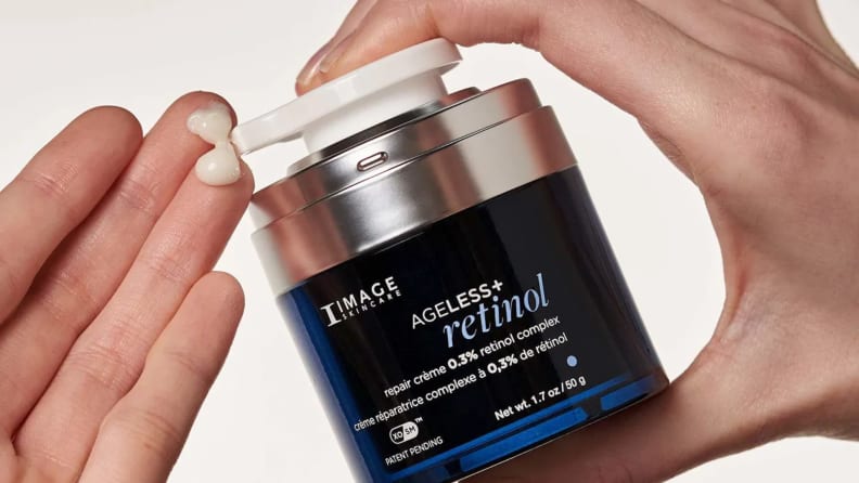 Model pumps IMAGE Skincare Retinol onto fingertips