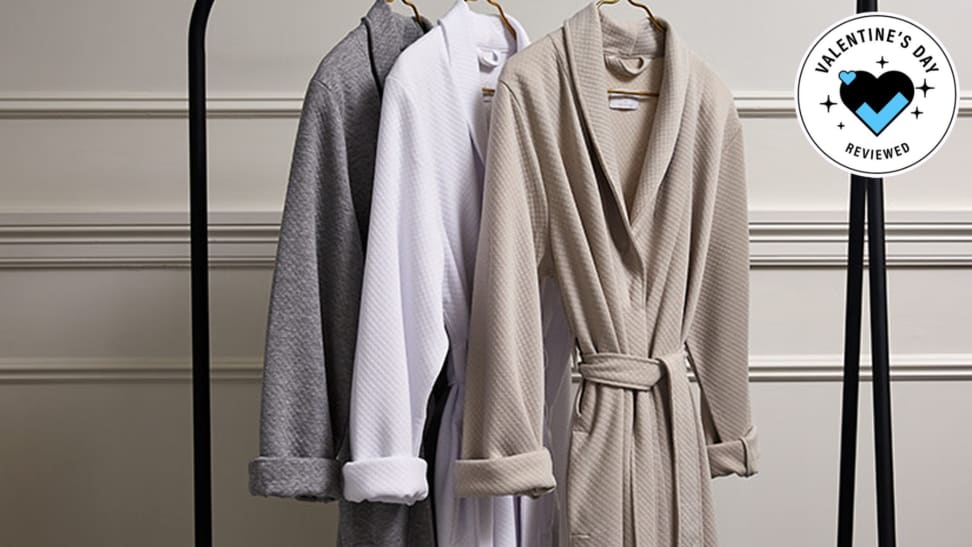 A set of Frette 1860 For St. Regis Diamond Jersey Robes hanging in front of the Valentine's Day Reviewed badge.